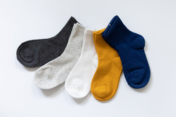 5 Pairs of children's socks in Blue, gray, mustard, yellow, white on a white background
