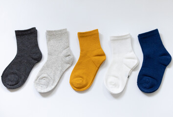 5 Pairs of children's socks in Blue, gray, mustard, yellow, white on a white background