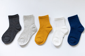 5 Pairs of children's socks in Blue, gray, mustard, yellow, white on a white background
