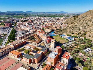 Aerial shot, drone point of view of ancient spanish city of Orihuela with building and mountains...