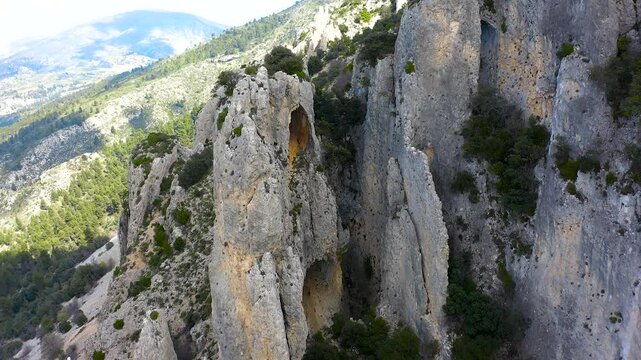 Aerial view of Els Frares. The topography, with its rock formations, casts a striking silhouette. Its striking structures resemble monks turned to stone, in Alicante, Spain.