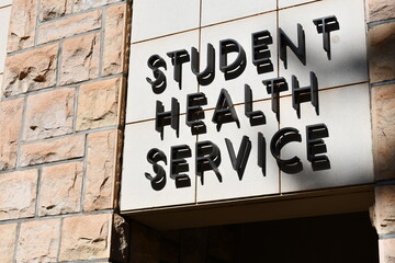 Student health service sign mounted on building.