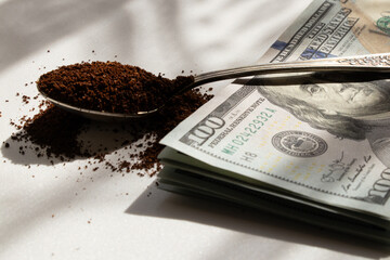 Old spoon with ground coffee and dollars, the aroma of the beginning of the day, scattered ground...