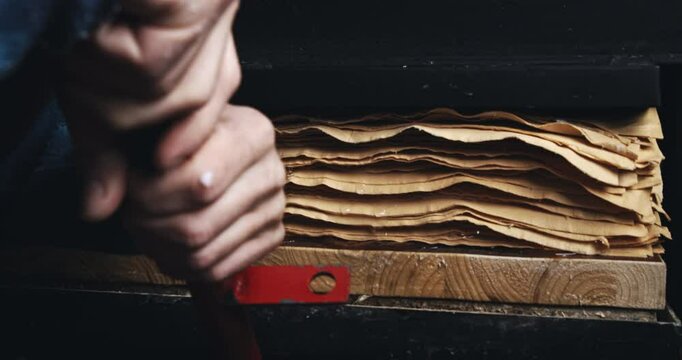 Super Slow Motion Close Up of Drying Stack of Handmade Paper Sheets Between Wooden Boards in Traditional Pressing Process for Craft Paper Production in Artisan Workshop at 1000 fps.