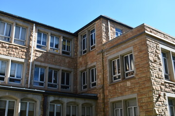 Old stone building on large school campus.