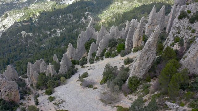 Aerial view of Els Frares. The topography, with its rock formations, casts a striking silhouette. Its striking structures resemble monks turned to stone, in Alicante, Spain.
