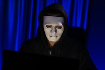 White criminal anonymous mask installing coding password encryption by programming hack, trying to...
