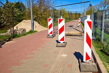 A metal fence encloses the work site.