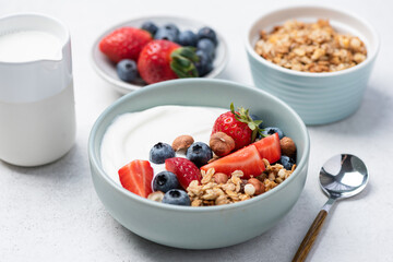 Granola, berry fruits and greek yogurt bowl