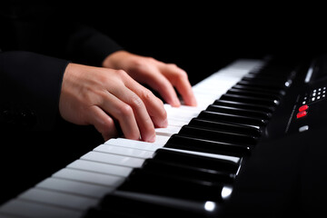 Fototapeta premium Hands play a melodic tune on a piano during an intimate evening performance