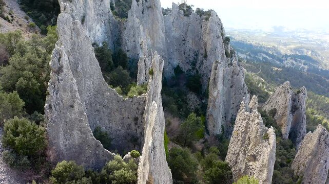 Aerial view of Els Frares. The topography, with its rock formations, casts a striking silhouette. Its striking structures resemble monks turned to stone, in Alicante, Spain.