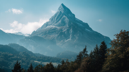 Majestic mountain peak stands tall against a clear blue sky, surrounded by lush green forests and rolling hills in a serene alpine landscape on a sunny day.