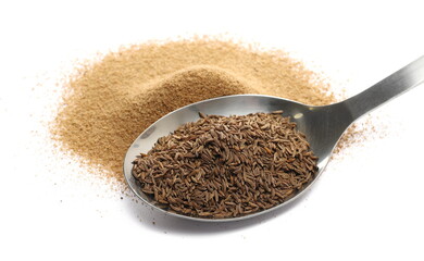Cumin seeds in metal spoon and ground pile, caraway grains isolated on white background, side view	