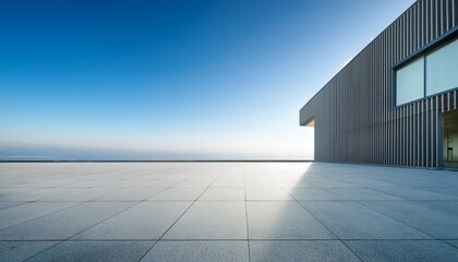 Obraz premium sleek modern architectural facade with empty concrete floor and clear blue sky