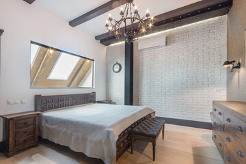 Exquisite bedroom design. White walls with black beams. Minimalism in interior design..