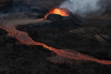 Hot, Glowing Lava Flowing from a Volcano Crater. Volcanic Eruption in Iceland.