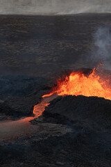Hot, Glowing Lava Flowing from a Volcano Crater. Volcanic Eruption in Iceland.