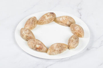 Homemade Cold appetizer. Chicken jellied meat in the shape of a quenelle. White background
