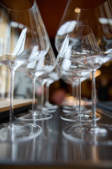 Clean wine glasses are on the table of a special wine cabinet, stylish table setting, ice, bottle of sparkling wine, light from window, decoder and degasser