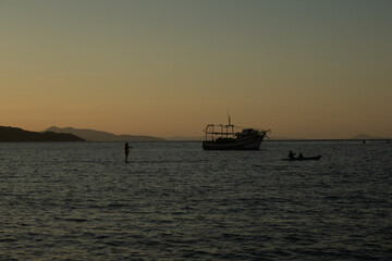 Golden Coastline Sunset – Boats, Nature and Ocean Calm