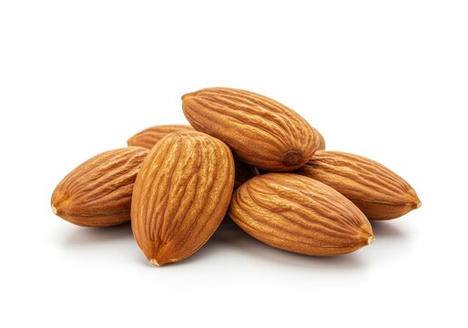 Pile of almonds on a white surface in a studio setting