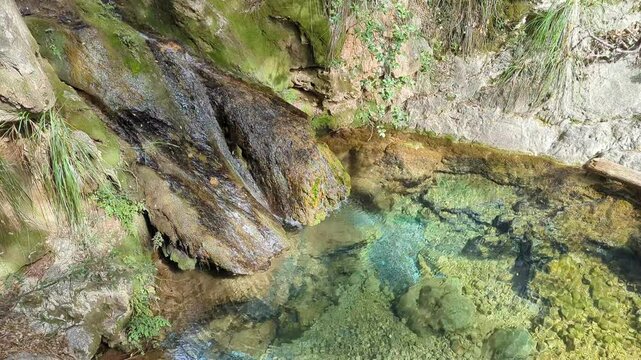 Torrent de Pastoritx, small gorge, waterfall with crystal clean clear water in nature, Valldemossa, Sa Raixa hiking route, Mallorca, Balearic Islands. Natural environment, spring hiking trail. 