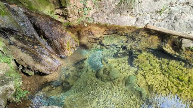 Torrent de Pastoritx, small gorge, waterfall, crystal clean clear water flowing in nature, Valldemossa, Sa Raixa hiking route, Mallorca, Balearic Islands. Natural environment, spring hiking trail.