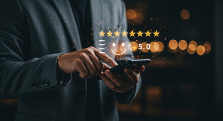Man in suit using smartphone with five star rating and smiley face overlay on dark bokeh background selling, purchasing, agreement, $