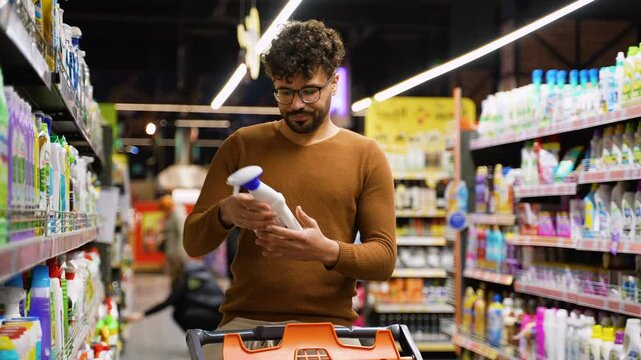 Arab man shopping for cleaning supplies in store
