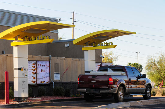 A pickup truck waits at a dual-lane McDonald's drive-thru, showcasing the fast-food chain's high-throughput ordering system designed to meet demand for speed, convenience, and mobile integration