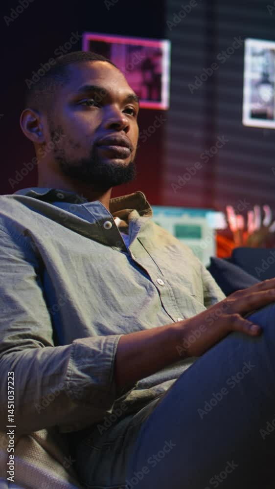 Poster vertical video african american guy engaging in a virtual workshop to learn skills for new job, inte
