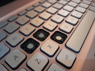 Close-Up of Damaged Laptop Keyboard with Missing Keys