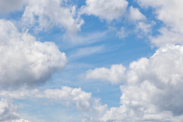 White cumulus clouds are creating a beautiful scene in the vast blue sky