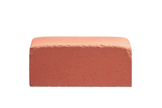 A red brick isolated on a black background is lit on the front and top surface