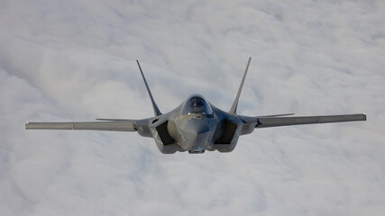 Very  close frontal view of a F-35C Lightning II   over clouds