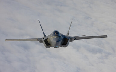 Very  close frontal view of a F-35C Lightning II   over clouds