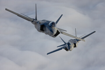 Very  close top view of a pair of F-35C Lightning II   over clouds