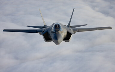Very  close frontal view of a F-35C Lightning II   over clouds
