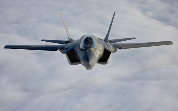 Very  close frontal view of a F-35C Lightning II   over clouds