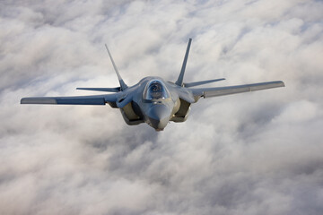 Very  close frontal view of a F-35C Lightning II   over clouds