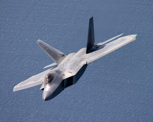 Close view of a a F-22 Raptor  flying over the Pacific ocean