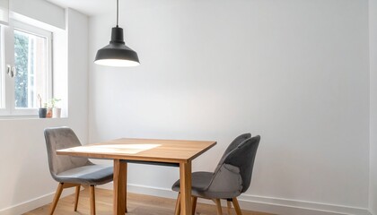A single pendant light over a simple wooden dining table with two chairs – Minimalist Living

