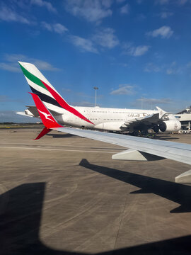 Parked Emirates and Qantas Aircraft Seen from Plane Window at Sydney Airport