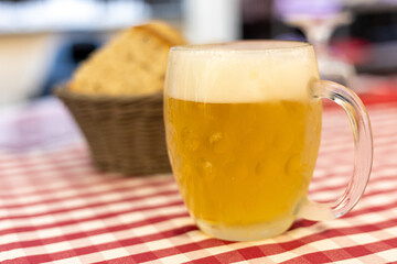 Refreshing beer served with bread in a cozy dining setting during an evening gathering