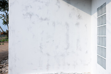 Skim coat on concrete wall for flat smooth. Include glass block brick wall. To plaster or apply white compound mortar cement material on surface for repair, improvement by builder professional.