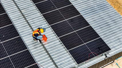 Workers installing and inspecting solar panels on a rooftop in a sunny environment, highlighting renewable energy, sustainability, and efficient use of modern technology in solar power systems.