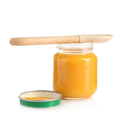 Baby food. Tasty puree in glass jar and spoon isolated on white