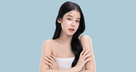 Obraz premium Glowing skin make up style of beautiful young Asian model isolated on blue background.