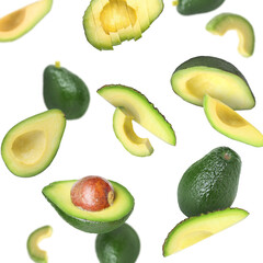 Fresh avocado fruits falling on white background