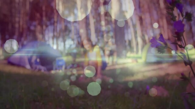 Friends exploring technology via animated trail map and weather icons at forest campsite